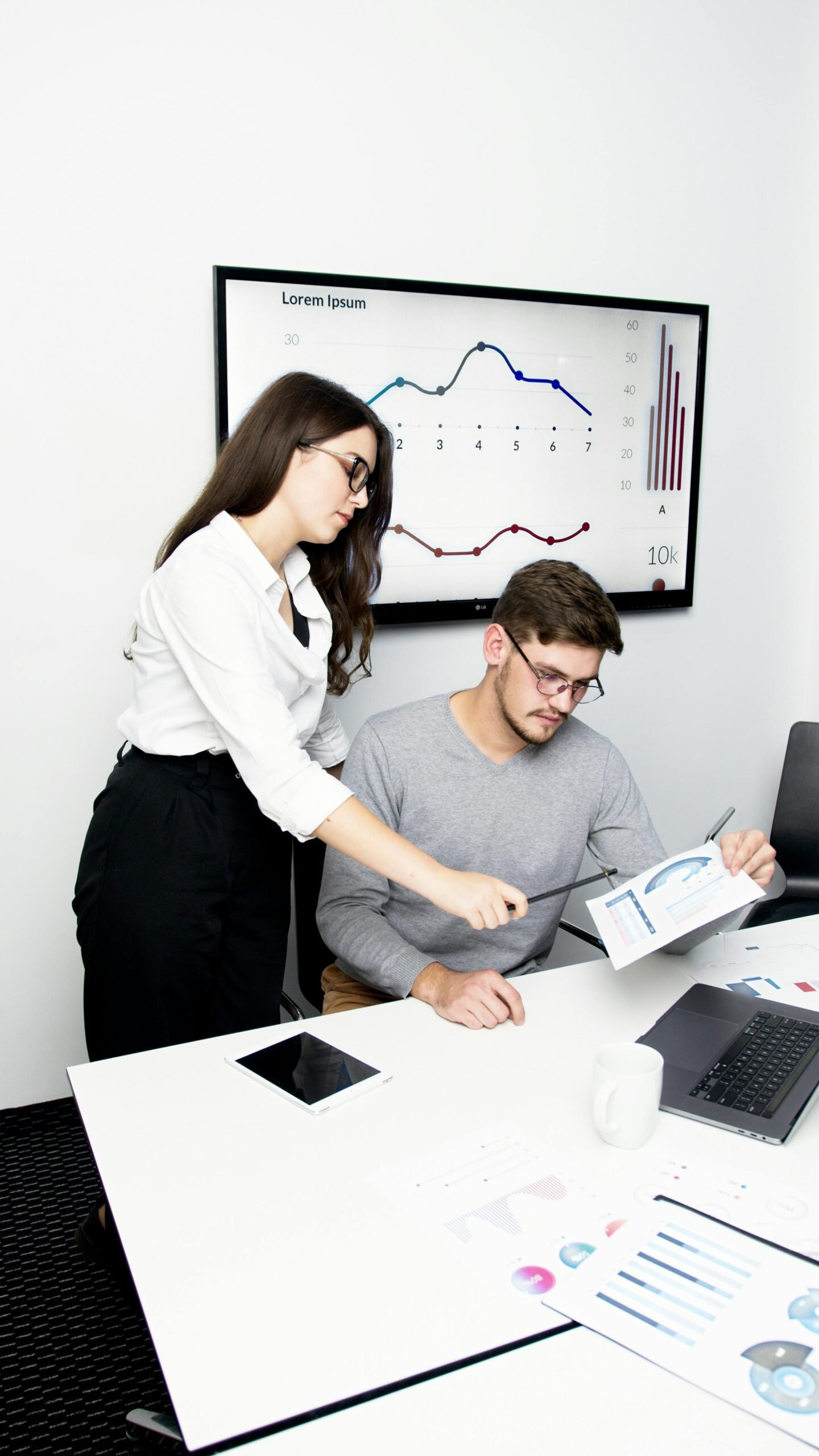 Man and Woman Holding White Tablet Computer