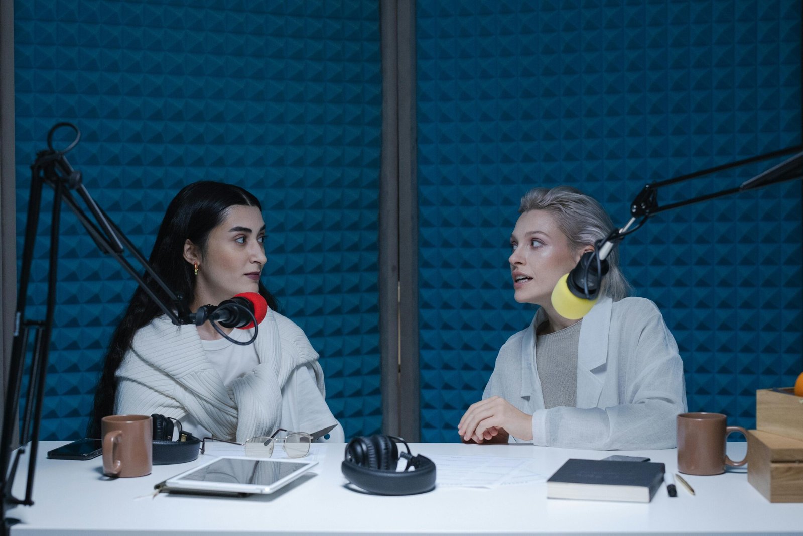 Women Having Conversation Inside the Studio while Looking at Each Other